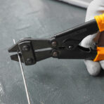 Close-up of Tolsen 8 inch mini bolt cutter cutting thin wire