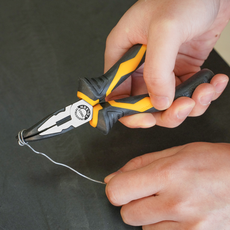 Close-up of hand using Tolsen 6-inch bent nose pliers to bend wire, with dark background