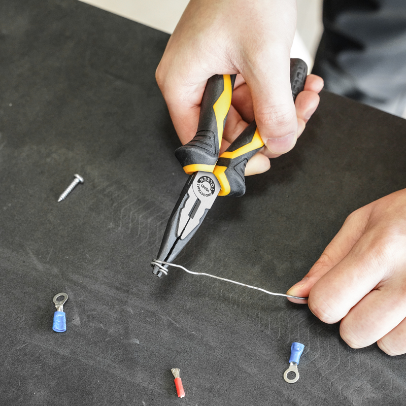 Close-up of hand using Tolsen 6-inch long nose pliers to bend wire