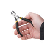 Close-up of hand holding Tolsen 4.5 inch mini diagonal cutting pliers