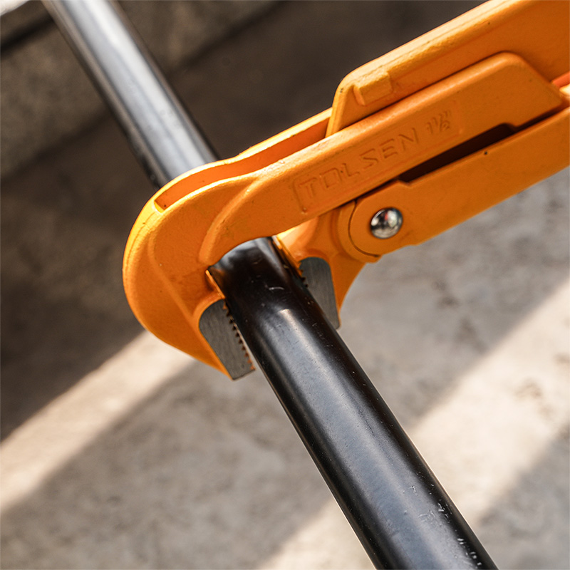 Close-up of Tolsen 90 degree bent nose pipe wrench gripping metal pipe