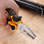 A close-up of a person using Tolsen 160mm pliers to cut iron wire