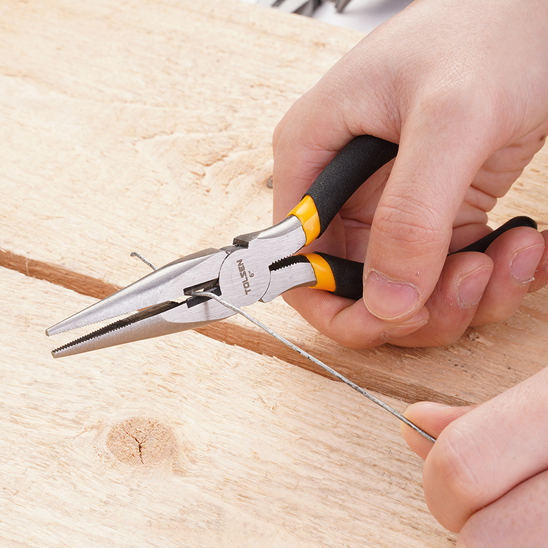 Close-up of Tolsen 6 inch long nose pliers cutting thin wire on wooden surface